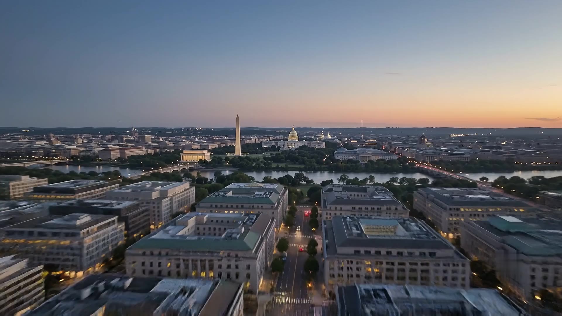 The Washington, DC skyline at dusk, seen from above the Potomac